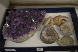 A large piece of amethyst crystal and various other crystals.