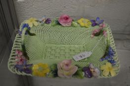 A Crown Staffordshire floral decorated porcelain twin handled basket and similar smaller basket.