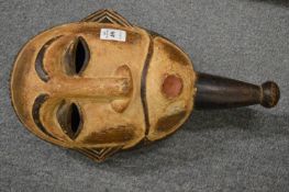 A carved wood and painted tribal mask.