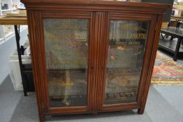 A Victorian walnut two door advertising or shop display cabinet for the Parisian firm Jiraud, each