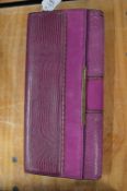 A ladies Vince Camuto purple leather clutch bag.