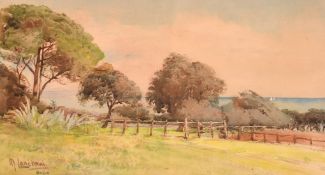 M. Lanciani (1873-1953), view across a field with sailboats in a bay beyond, watercolour,