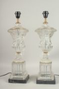 A GOOD PAIR OF GLASS URN SHAPED LAMPS on marble bases. 60cms high.