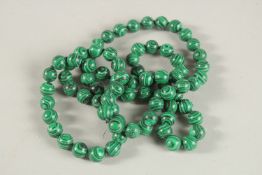 A STRING OF MALACHITE BEADS. 90cms long.