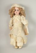 A WALKING JUMEAU BISQUE DOLL, FRENCH, CIRCA. 1900, impressed 8 with weighted dark blue eyes, open