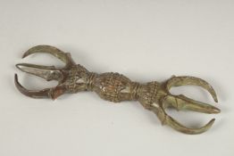 A TIBETAN BRONZE PHURBA. 14cms long.
