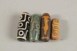 FOUR AGATE DZI BEADS.
