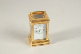 A GOOD MINI BRASS CARRIAGE CLOCK. 8cms high.
