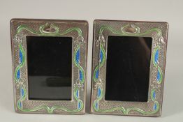 A GOOD PAIR OF ART NOUVEAU SILVER AND BLUE ENAMEL PHOTOGRAPH FRAMES. 19cms x 15cms.