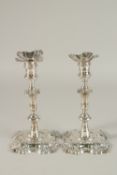 A PAIR OF GEORGE II CAST SILVER CANDLESTICKS. 21cms high. London 1752. Maker: W. S. Weight 32ozs.