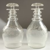 A GOOD PAIR OF GEORGIAN DECANTERS AND STOPPERS engraved with fruiting vines. 23cms high.