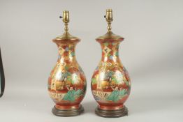 A LARGE PAIR OF SATSUMA POTTERY LAMPS on wooden bases.