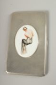 AN ENGINE TURNED SILVER CIGARETTE CASE. Birmingham 1940, with a glamour model enamel.