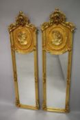 A PAIR OF TALL LOUIS XVITH STYLE UPRIGHT MIRRORS with a young girl in an oval. 180cms high x 50cms