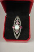 A SILVER OPAL AND RUBY RING.