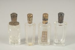 FOUR SILVER TOP SCENT BOTTLES.
