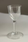A GEORGIAN WINE GLASS with plain bowl and stem. 14cms high.