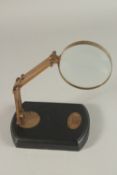 A BRONZE MAGNIFYING GLASS on a stand.