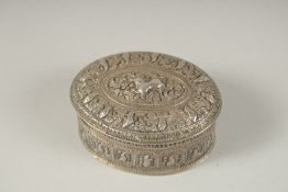 A TIBETAN SILVER OVAL BOX. 6.5cms.