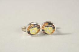 A PAIR OF STERLING SILVER AND ENAMEL PORSCHE EMBLEM CUFFLINKS.
