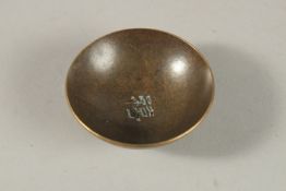 A SMALL CHINESE BRONZE CIRCULAR BOWL. 5.5cms diameter.
