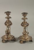 A GOOD PAIR OF 19TH CENTURY PLATE CUPID CANDLESTICKS by WALKER & HALL, SHEFFIELD, the bases with