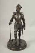 A GOOD BRONZE OF A KNIGHT in armour, carrying a sword, on a circular base. 40cms high.