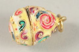 A TINY SILVER AND ENAMEL EGG PENDANT.