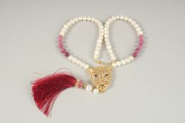 A SILVER AND GOLD PLATED PANTHER NECKLACE with pearls and rubies.