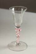 A GEORGIAN WINE GLASS with inverted bell bowl and coloured twist stem.