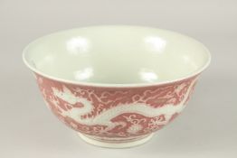 A CHINESE COPPER RED WHITE DRAGON BOWL. 22cms diameter.