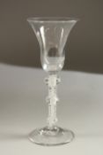 A GEORGIAN WINE GLASS with tapering inverted bowl and air twist stem with knop. 18cms high.