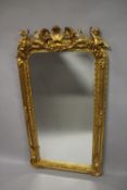 A GOOD LOUIS XVITH GILTWOOD UPRIGHT MIRROR with cupids, scrolls and garlands. 152cms high x 76cms