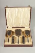 A FIVE-PIECE SILVER AND TORTOISHELL DRESSING TABLE SET, in a fitted case.