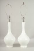 A PAIR OF 1920'S-1930'S WHITE GLASS BULBOUS LAMPS with chrome fittings. 50cms high.