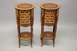 A PAIR OF LOUIS XVITH DESIGN INLAID CIRCULAR BEDSIDE TABLES with three drawers, on curving legs