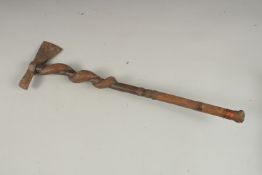 A BRITISH MADE INDIAN TRIBAL AXE with entwined wooden handle. 62cms long.