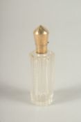 A GOLD TOP CUT GLASS SCENT BOTTLE. 8cms long.