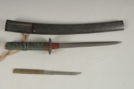 A 18TH CENTURY JAPANESE TANTO with bound shagreen handle and Tsuba. Polished blade in a lacquer