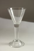 A GEORGIAN WINE GLASS with tapering bowl and stem. 17cms high.