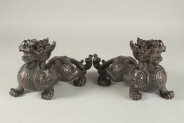 A PAIR OF CHINESE BRONZE DRAGONS. 25cms high.