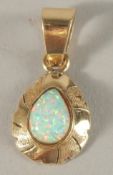 A 14CT OPAL SET PENDANT.