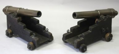 A GOOD PAIR OF BRONZE CANNONS AND WOODEN STANDS stamped SV JURA 1875. Built and launched 28/8/