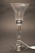 A GOOD GEORGE III WINE GLASS with baluster stem and bell shaped bowl.