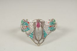 A SILVER RUBY, EMERALD AND SAPPHIRE DRAGONFLY BANGLE.