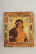 A LARGE RUSSIAN ICON, Madonna and Child, four saints to the border. 50cms x 44cms.