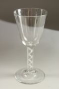 A LARGE GEORGIAN WINE GLASS with plain bowl and air twist stem. 19cms high.