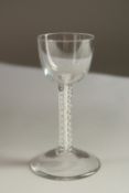 A GEORGIAN WINE GLASS with cup bowl and air twist stem. 15.5cms high.