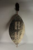 A ZULU SOUTH AFRICAN SHIELD covered in skin. 84cms high x 47cms wide at its longest point.