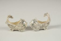 A PAIR OF PLATE DOLPHIN SALTS AND SPOONS.